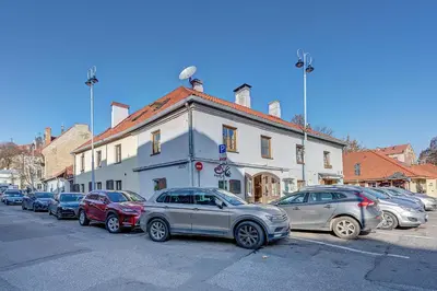 a group of cars parked in front of a building at Vidos apartamentai 2 in Vilnius
