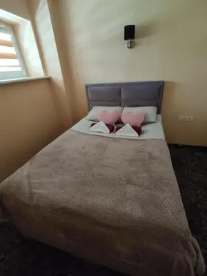 a bedroom with a bed with two pillows on it at Kaimo turizmo sodyba 