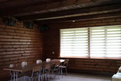 a room with a table and chairs and a window at Kaimo turizmo sodyba 