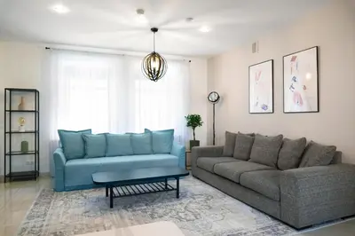 a living room with a couch and a table at Kaunas Old Town Apartment in Kaunas