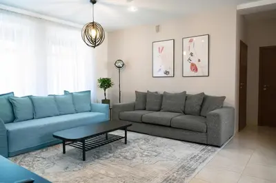 a living room with two blue couches and a table at Kaunas Old Town Apartment in Kaunas