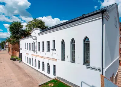 a white building with windows on a street at Piano Apartments in Kaunas