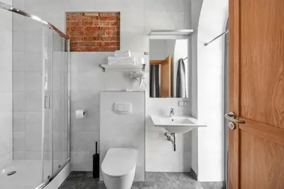 a bathroom with a toilet and a sink and a shower at Piano Apartments in Kaunas