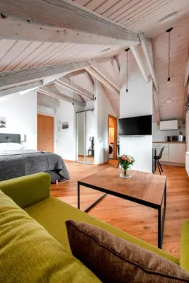 a living room with a bed and a coffee table at Piano Apartments in Kaunas