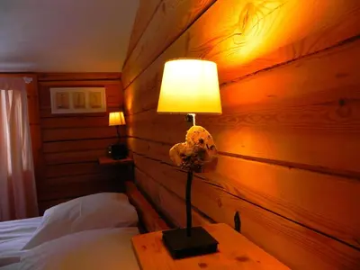 a lamp sitting on a table in a bedroom at Aliai in Utena
