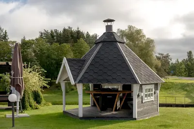 a gazebo with a table in it at Butenas Hotel Tyla in Biržai