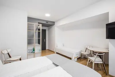 a bedroom with a bed and a table and chairs at #draugunamai in Druskininkai