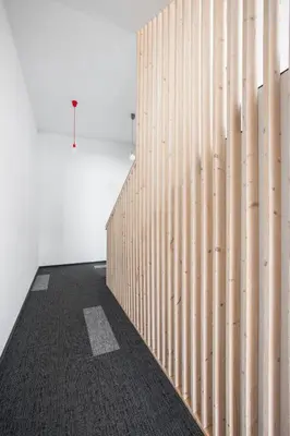 a hallway with a wooden wall in a room at #draugunamai in Druskininkai