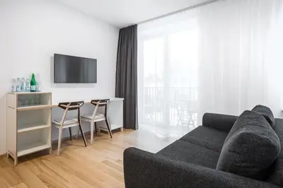 a living room with a couch and a table with chairs at #draugunamai in Druskininkai