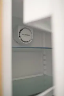 a microwave sitting on a shelf in a refrigerator at Penthouse in Druskininkai
