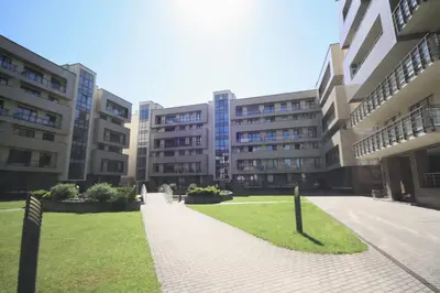 a large building with a lawn in front of it at Penthouse in Druskininkai
