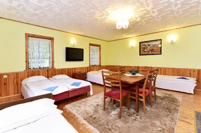 a room with two beds and a table and chairs at 