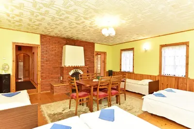 a room with a table and chairs and a bedroom at 