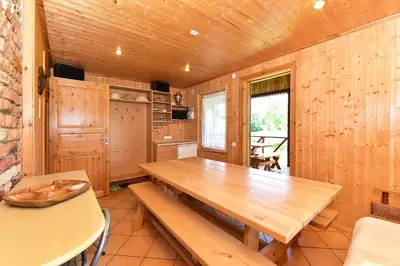 a dining room with a wooden table in a cabin at 