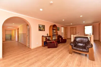 a living room with a leather chair and an archway at 