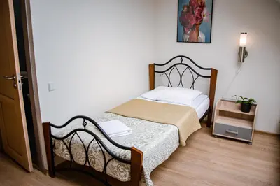 a small bedroom with a bed in a room at Hotel Pas Katina in Panevėžys