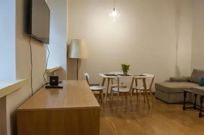 a living room with a couch and a table and chairs at Teatro Apartments in Vilnius