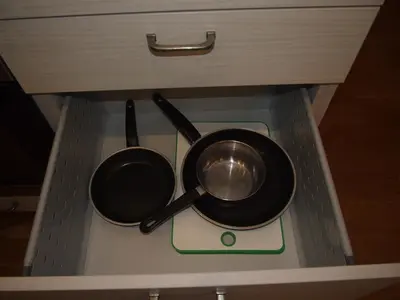 two pots and pans sitting on top of a stove at Teatro Apartments in Vilnius