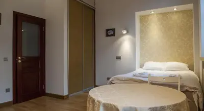 a room with two beds and a table in it at Teatro Apartments in Vilnius