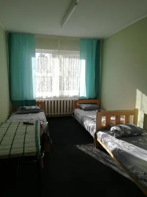 a room with two beds and a window in a room at Pasile in Kaunas