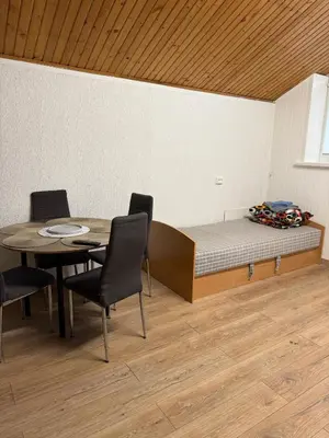 a room with a bed and a table and chairs at Pasile in Kaunas
