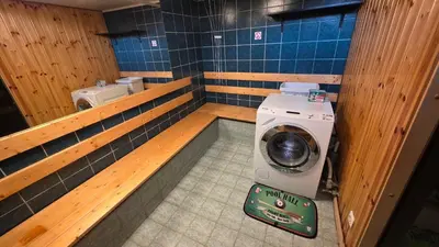 a small bathroom with a washing machine in it at ApartHotel SAVAS 4 Private house with parking in Kaunas