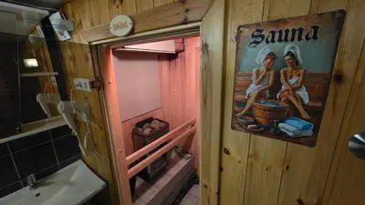 a bathroom with a painting of two women sitting on a barrel at ApartHotel SAVAS 4 Private house with parking in Kaunas