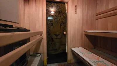 a tiger is seen through the door of a sauna at ApartHotel SAVAS 4 Private house with parking in Kaunas