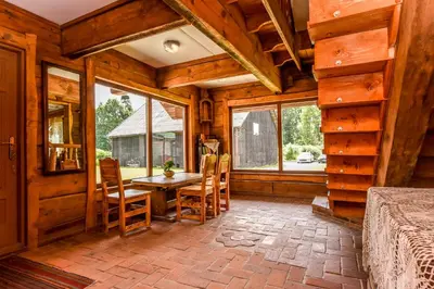 a dining room with a table and chairs in a cabin at Rasos sodyba in Prienai