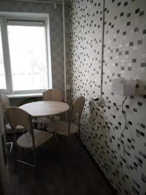 a room with a table and chairs and a window at Nakvynė Anykščių centre in Anykščiai
