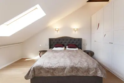 a bedroom with a large bed in a attic at #stayhere 3BDR Modern & Stylish Apartment - Heart of Old Town by Houseys in Vilnius