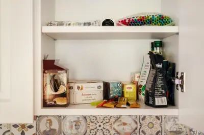 a kitchen pantry with food items on a shelf at #stayhere 3BDR Modern & Stylish Apartment - Heart of Old Town by Houseys in Vilnius