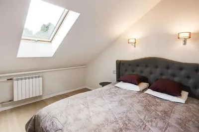 a bedroom with a large bed with a large window at #stayhere 3BDR Modern & Stylish Apartment - Heart of Old Town by Houseys in Vilnius