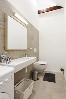 a bathroom with a sink and a toilet and a mirror at #stayhere 3BDR Modern & Stylish Apartment - Heart of Old Town by Houseys in Vilnius