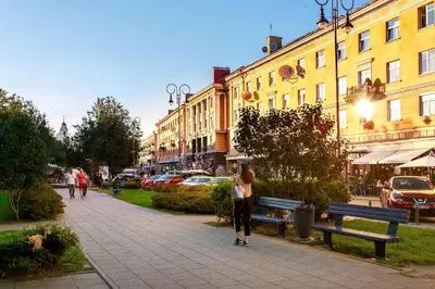 a woman standing on a sidewalk in a city at #stayhere 3BDR Modern & Stylish Apartment - Heart of Old Town by Houseys in Vilnius