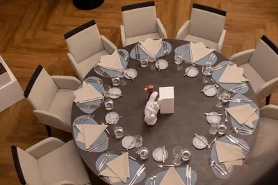 a table with wine glasses and envelopes on it at Hotel Vilnia in Vilnius