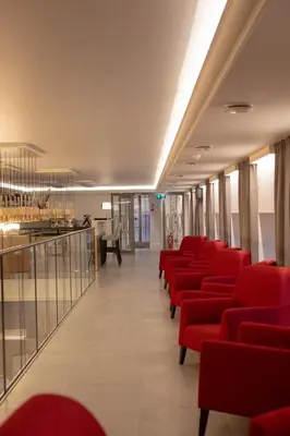 a row of red chairs in a waiting room at Hotel Vilnia in Vilnius