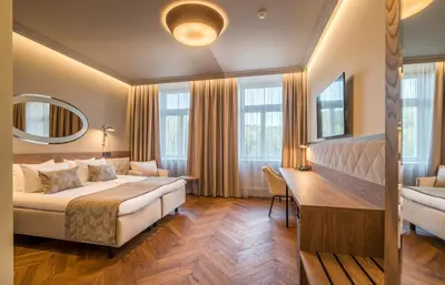a hotel room with a bed and a desk at Hotel Vilnia in Vilnius