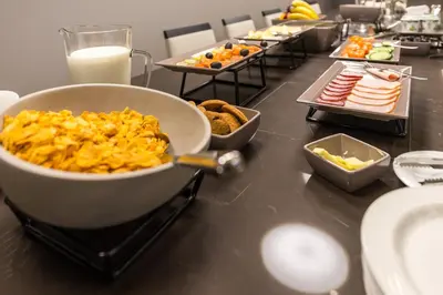 a buffet of food on a table with plates of food at Hotel Vilnia in Vilnius
