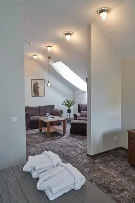 a living room with a couch and a table at Šaulys in Šiauliai