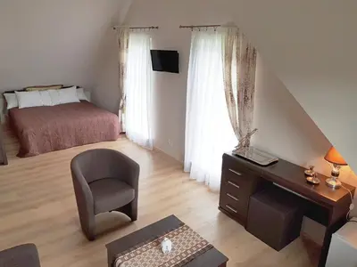a bedroom with a desk and a bed and a chair at 