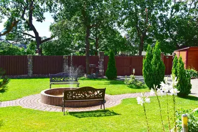 a garden with a bench and a fountain in the grass at 