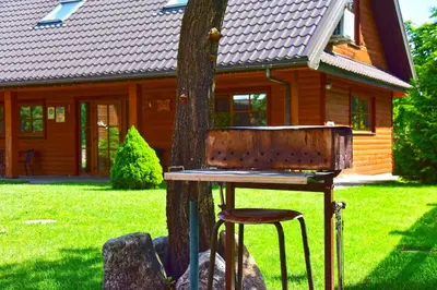 a wooden chair sitting next to a tree at 