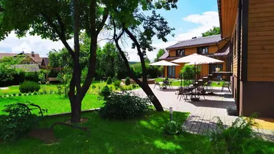 a patio with tables and umbrellas next to a house at 