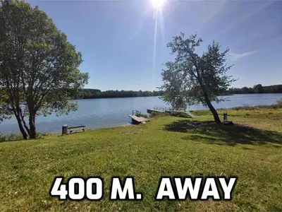 a sign that says away next to a lake at 
