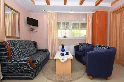 a living room with two chairs and a table at 