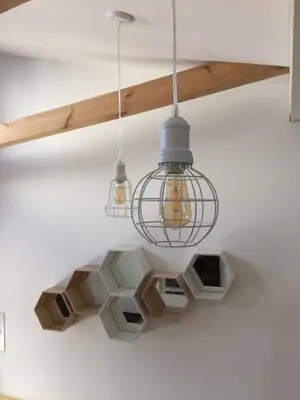 a chandelier hanging from a ceiling in a room at Jolie Apartments in Kaunas