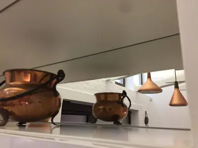 two vases sitting on a shelf in front of a mirror at Jolie Apartments in Kaunas