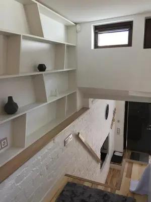 a room with white shelves and a window at Jolie Apartments in Kaunas