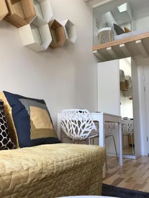 a living room with a couch and a table at Jolie Apartments in Kaunas